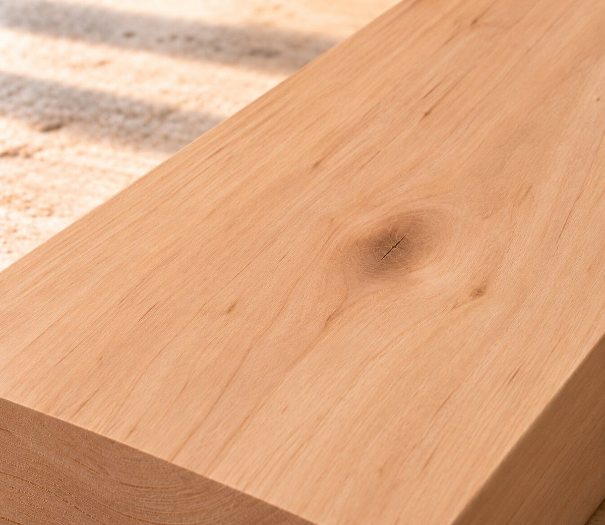 Close-up of solid alder board showing fine grain and a natural knot