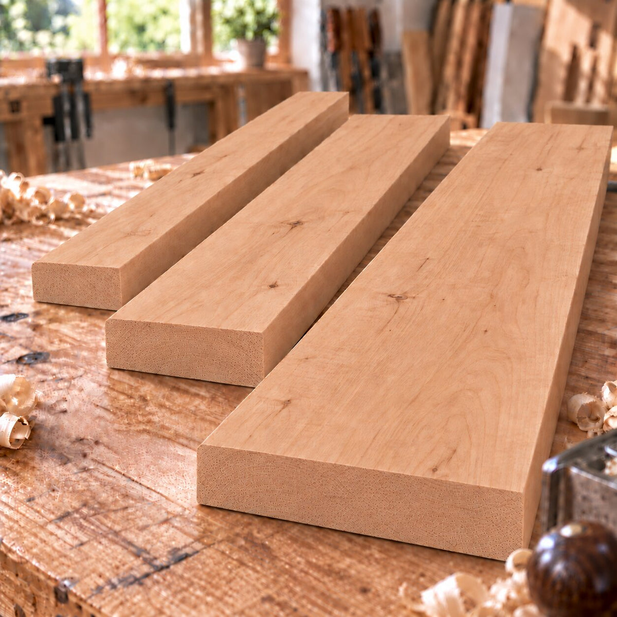 Solid alder boards in three different widths on a woodworking bench