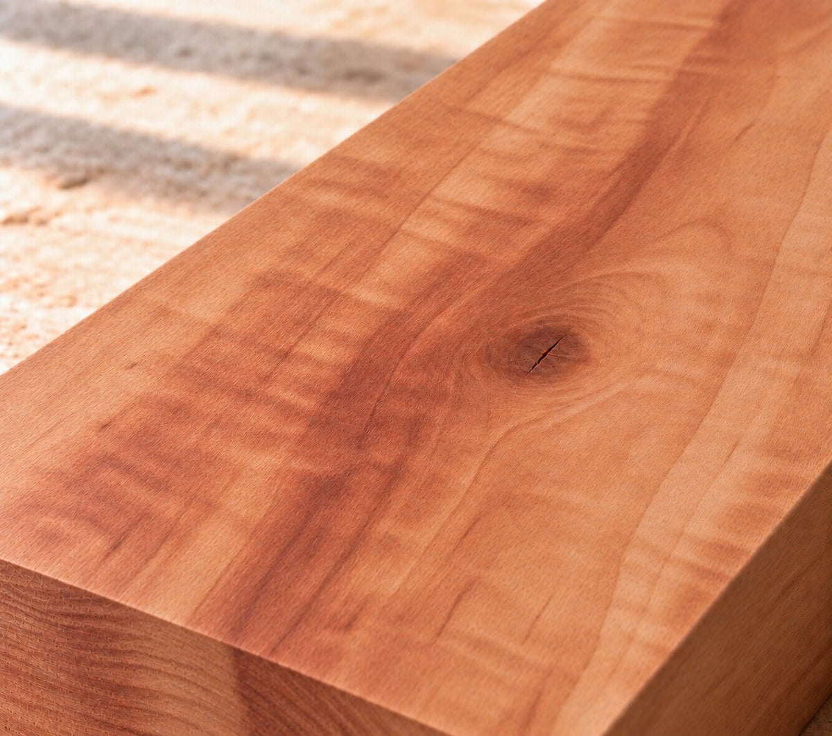 Close-up of solid apple wood showing fine grain and warm reddish-brown colour variation