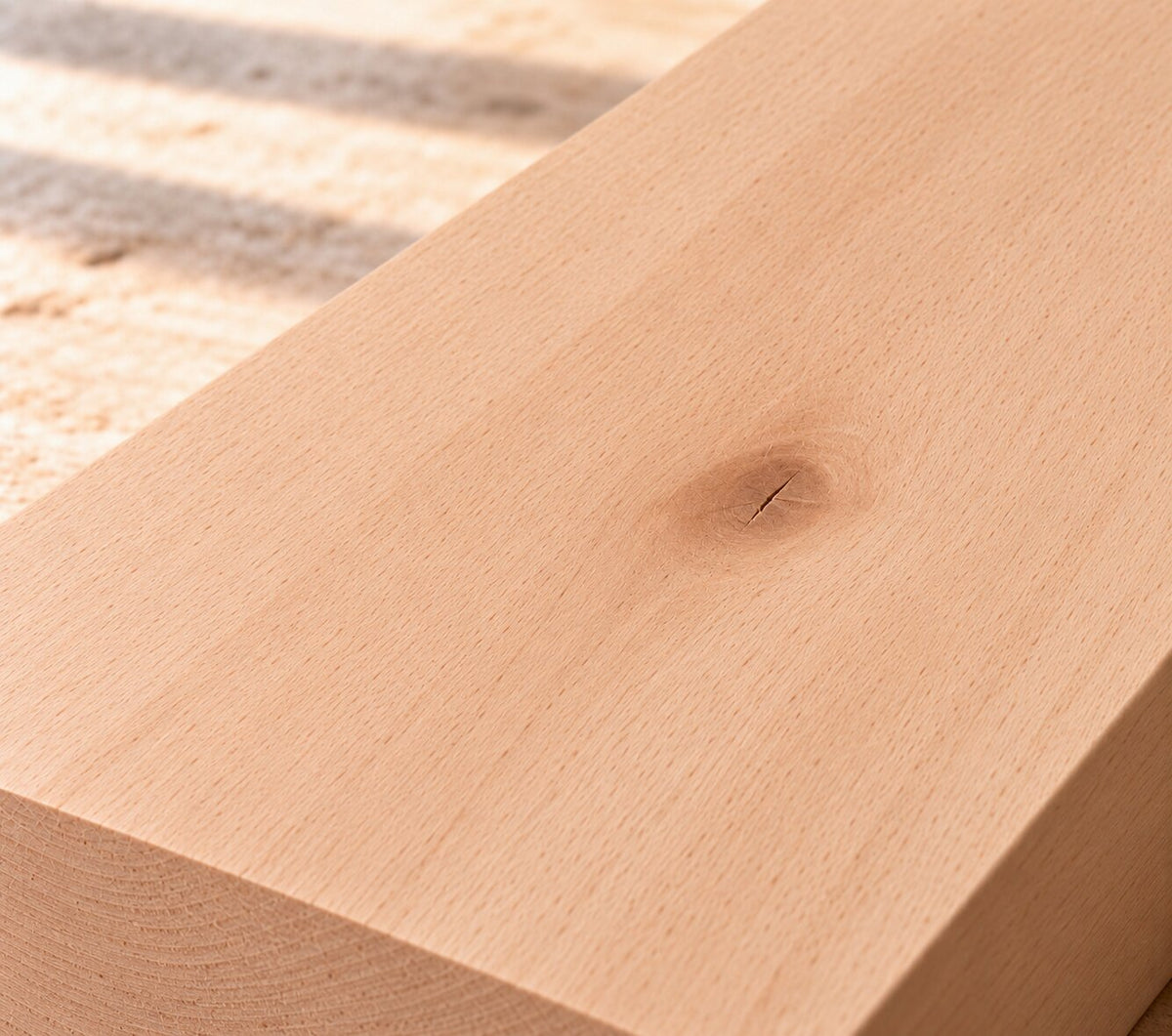 Close-up of solid beech board showing fine grain and a natural knot
