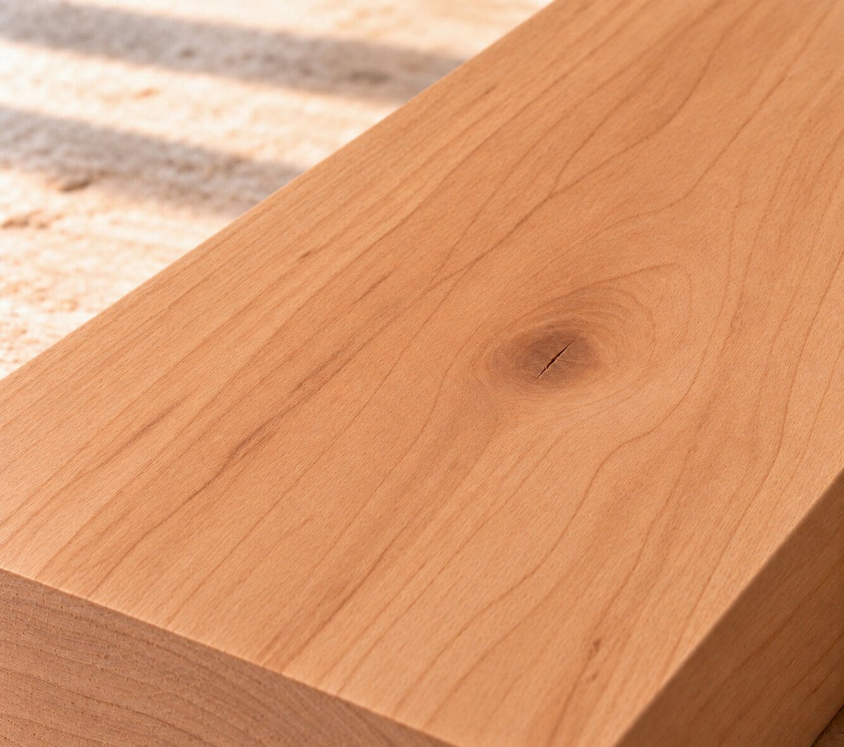 Close-up of solid European cherry board showing fine grain, warm colour and a natural knot