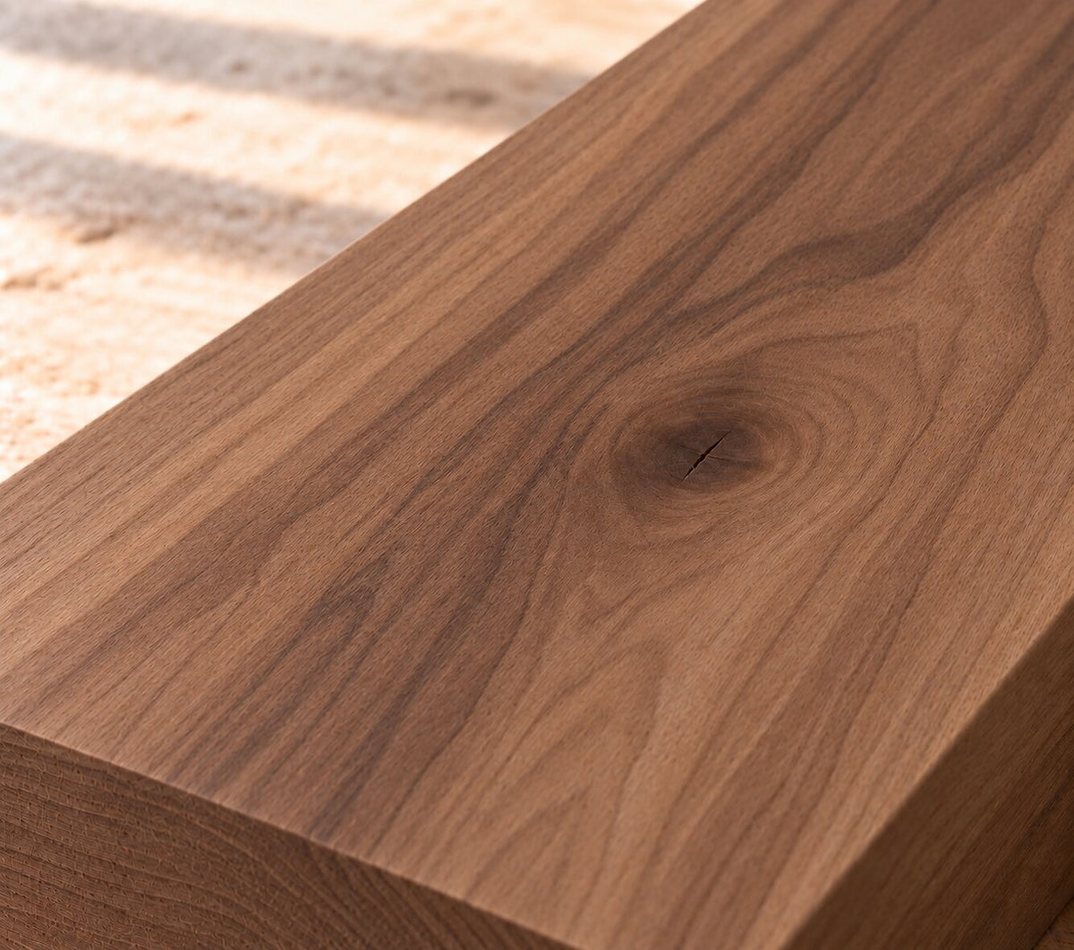Close-up of solid European walnut board showing rich grain, darker streaks and a natural knot